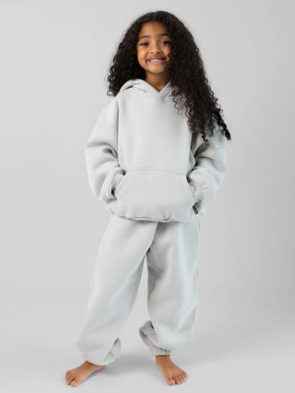 The Standard Kids Sweatpants: Malu is 5 wearing a size S