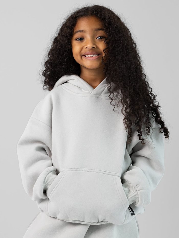 The Standard Kids Hoodie: Malu is 5 wearing a size S